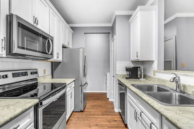 a kitchen with a sink stove and refrigerator
