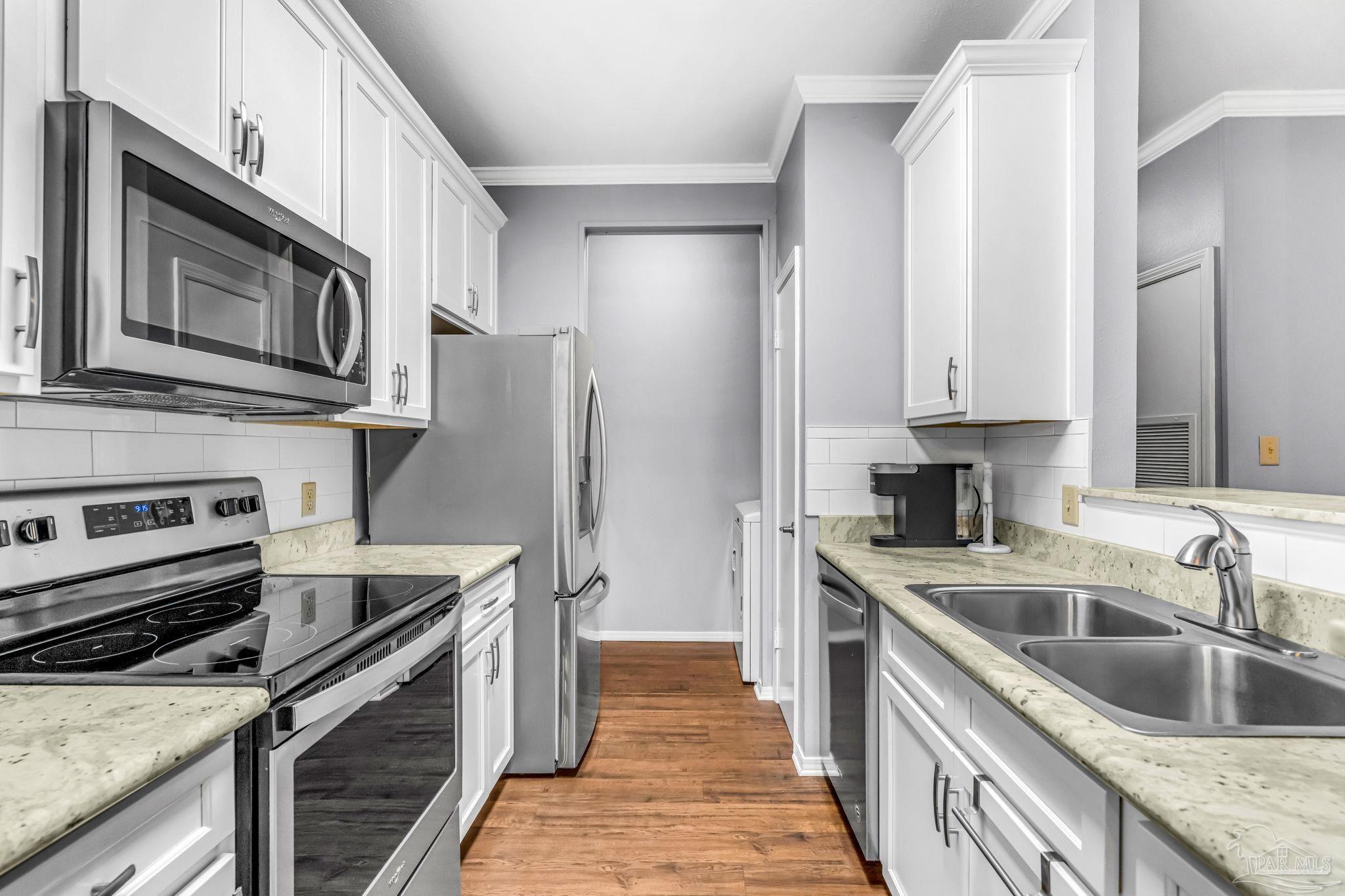 601 East Burgess Road, Unit C4 Pensacola, FL 32504 - Photo 15 of 28 a kitchen with a sink stove and refrigerator