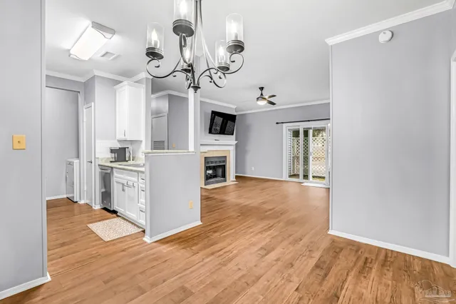 a view of a kitchen with a sink wooden floor and cabinets
