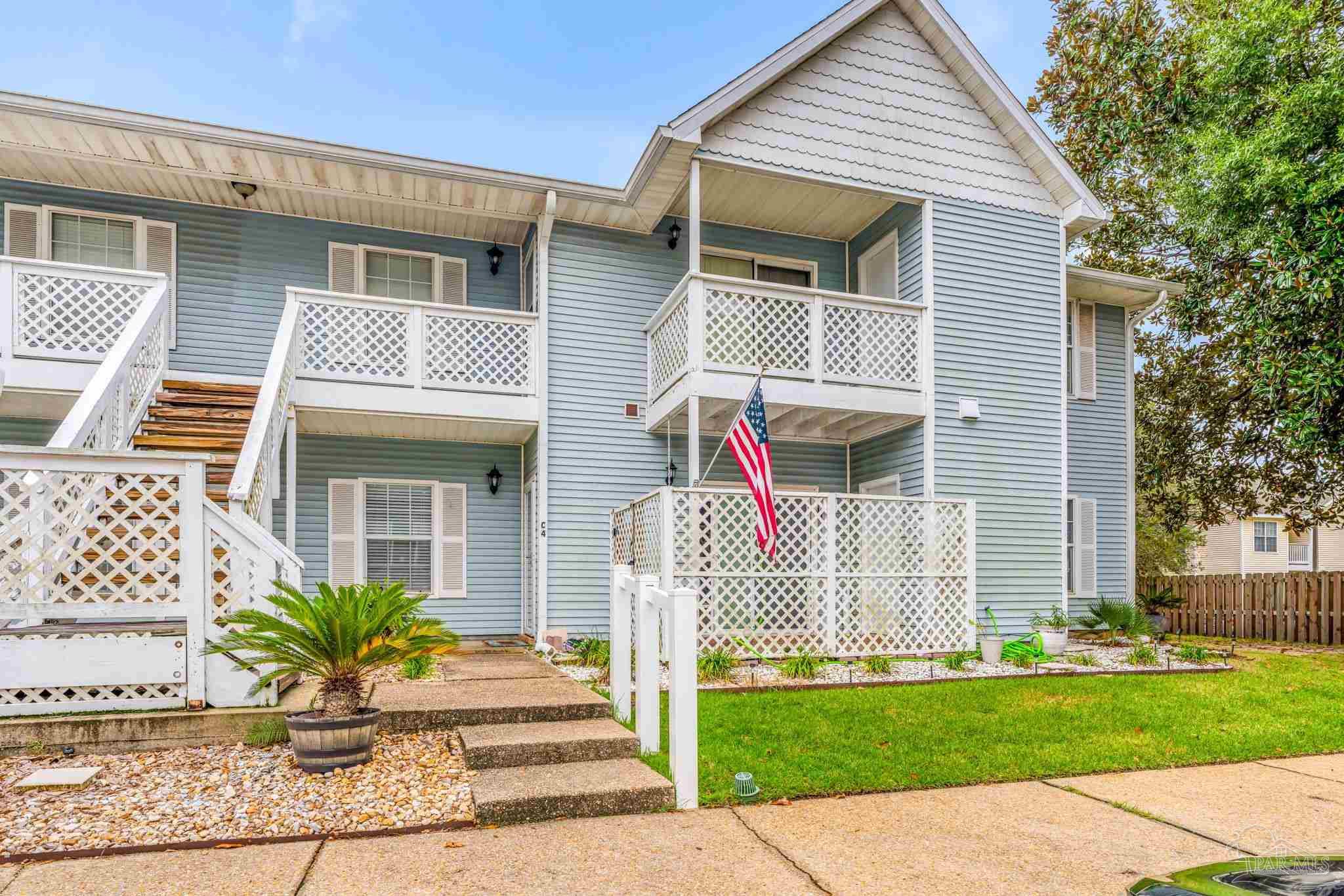 601 East Burgess Road, Unit C4 Pensacola, FL 32504 - Photo 2 of 28 a front view of a house with a garden