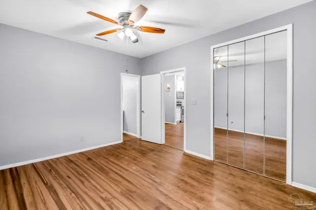 a view of an empty room with wooden floor