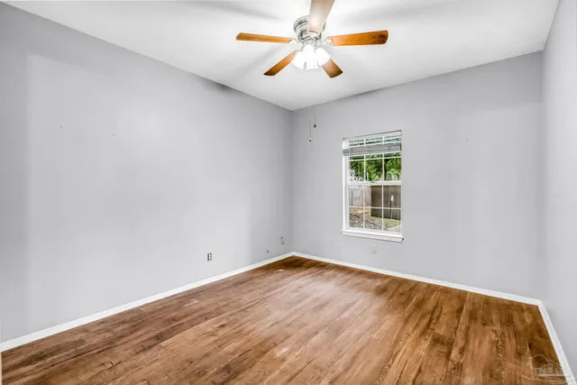 wooden floor in an empty room with a window