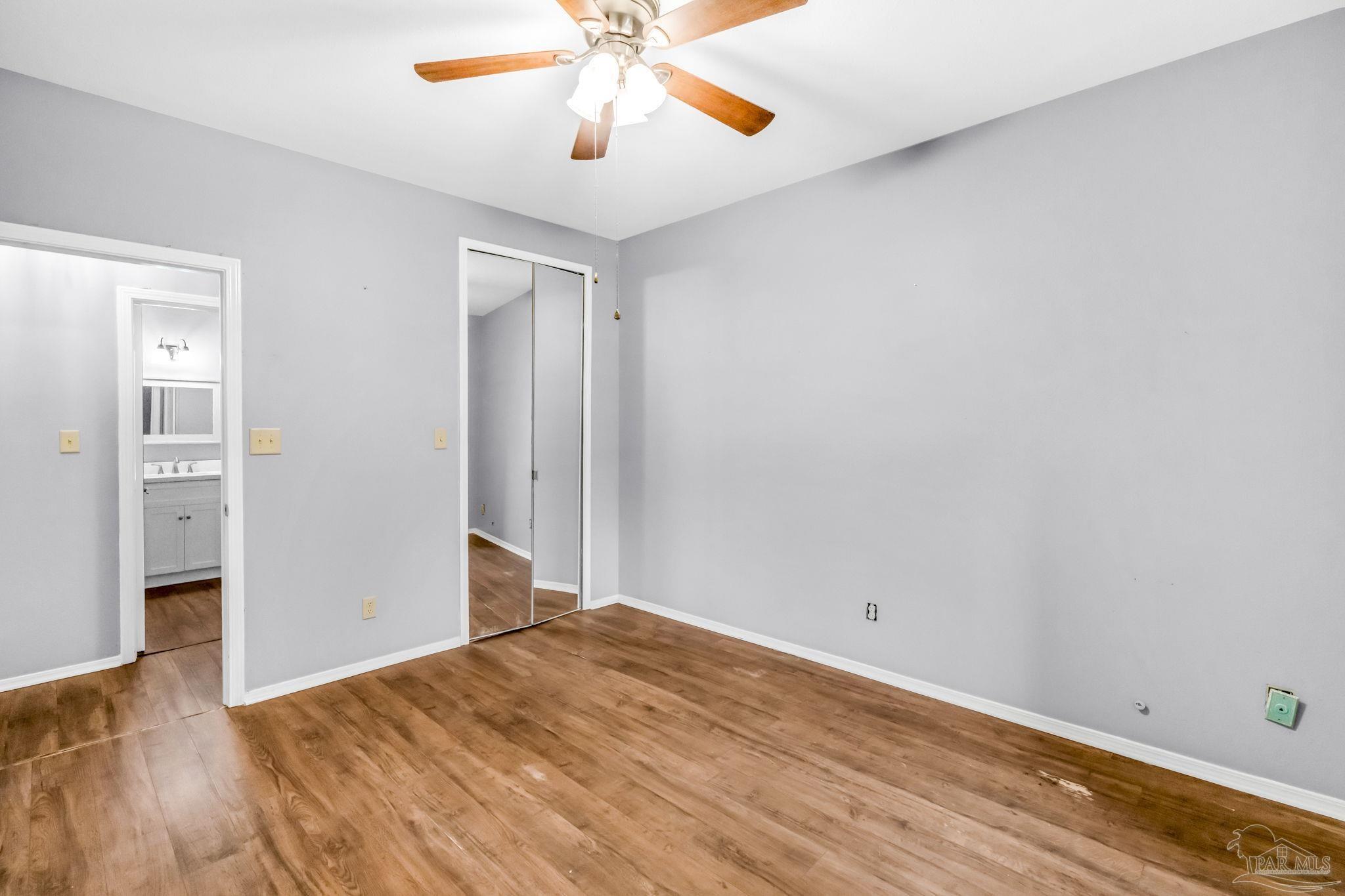 601 East Burgess Road, Unit C4 Pensacola, FL 32504 - Photo 25 of 28 wooden floor in an empty room with a window