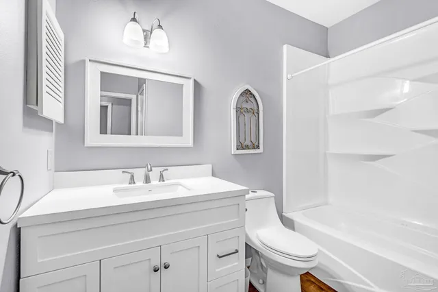 a bathroom with a sink a toilet and a bathtub