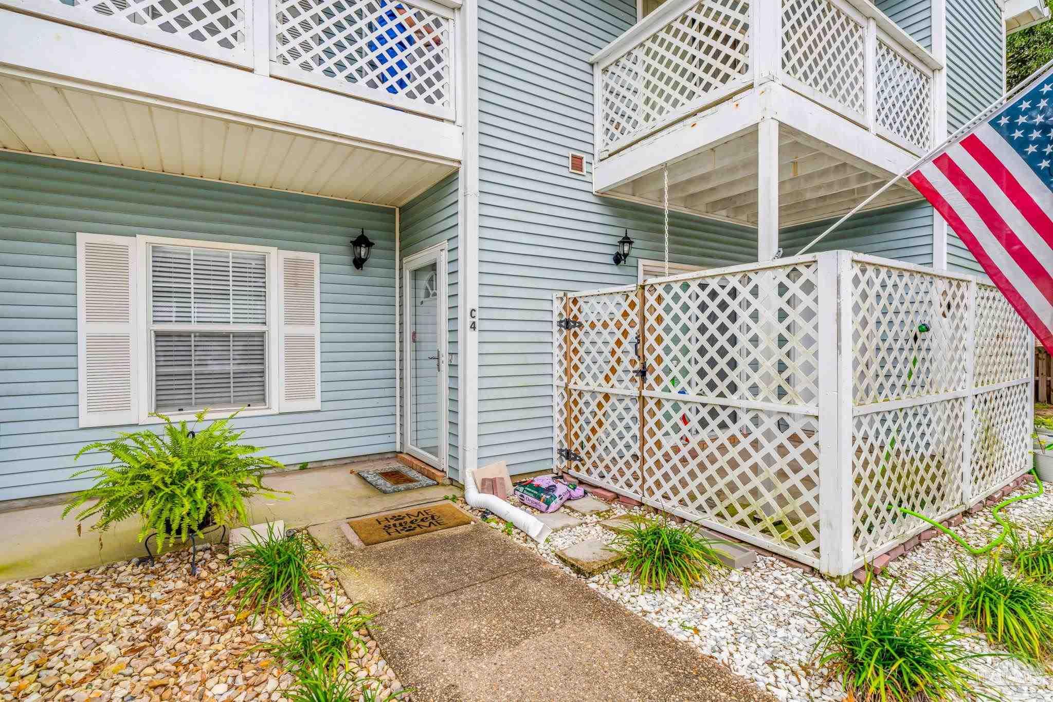 601 East Burgess Road, Unit C4 Pensacola, FL 32504 - Photo 4 of 28 a view of a house with a small yard and wooden fence
