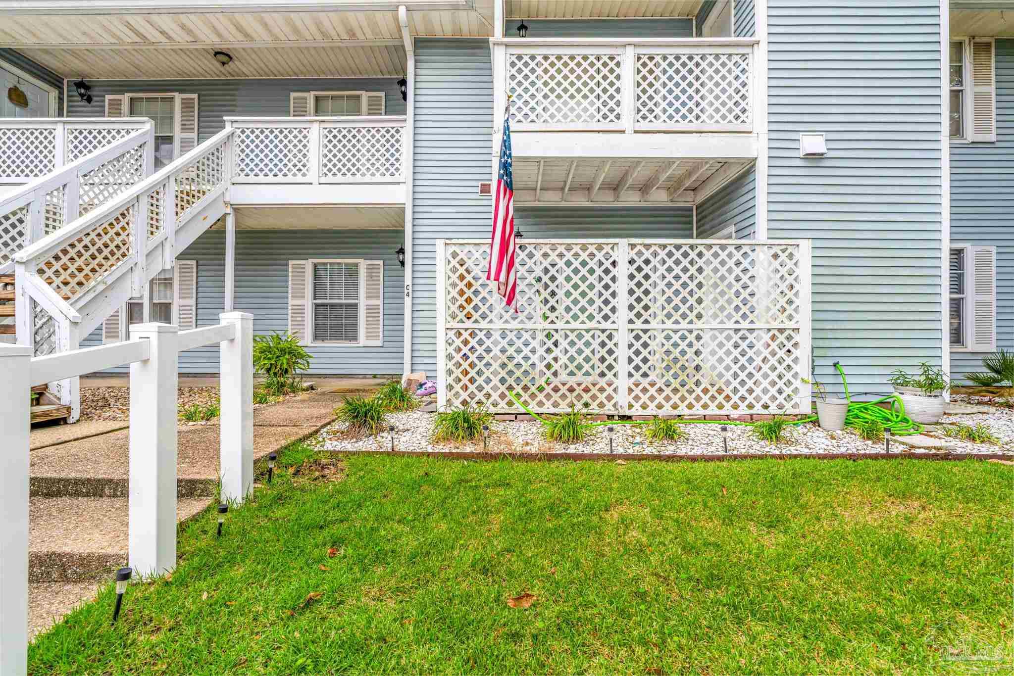 601 East Burgess Road, Unit C4 Pensacola, FL 32504 - Photo 6 of 28 a front view of a house with a yard and garage