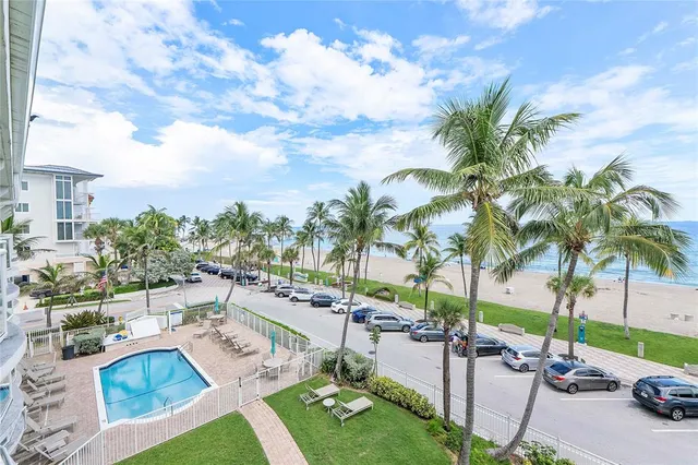 a bathroom with a granite countertop sink a toilet a shower and a mirror