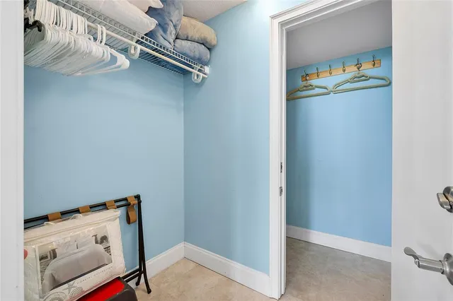 a bed room with two bed and a dresser