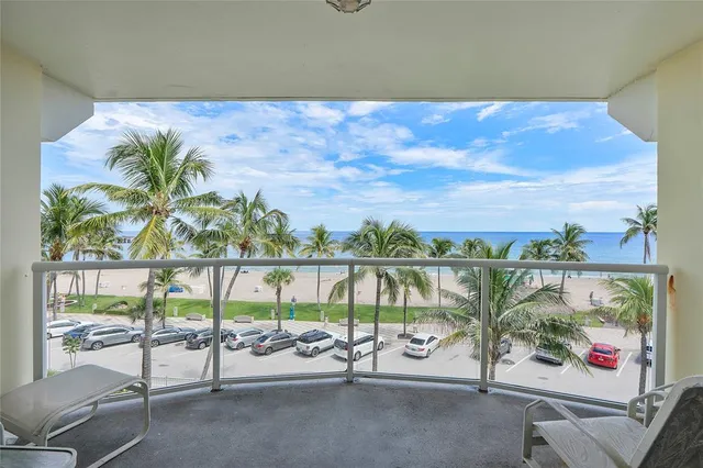 a bedroom with a bed and a flat tv screen on dresser