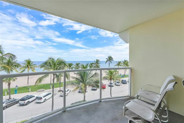 a bathroom with a granite countertop sink and a toilet