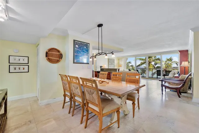 a large kitchen with stainless steel appliances kitchen island granite countertop a sink refrigerator and cabinets