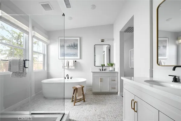 a spacious bathroom with a sink double vanity and a mirror