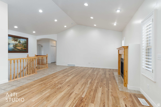 2327 Bluff Ridge Drive Syracuse, UT 84075 - Photo 13 of 66 Spacious living area featuring wood-finish flooring, a fireplace with a wood mantle, recessed lighting, and white plantation shutters