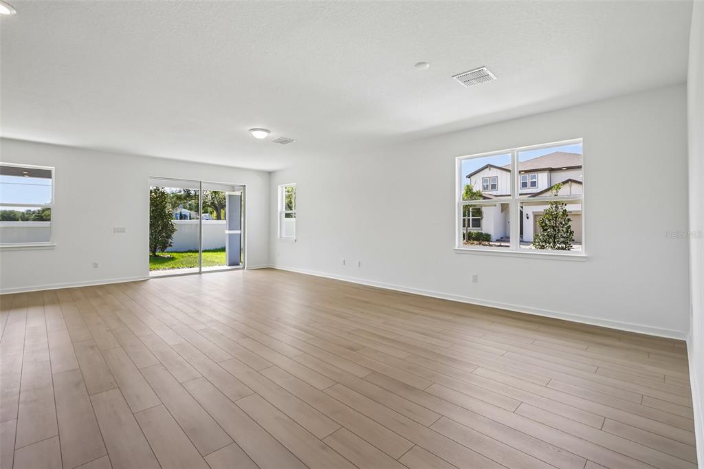 9932 Redwood Rdg Avenue Riverview, FL 33578 - Photo 10 of 38 a view of an empty room with window and wooden floor