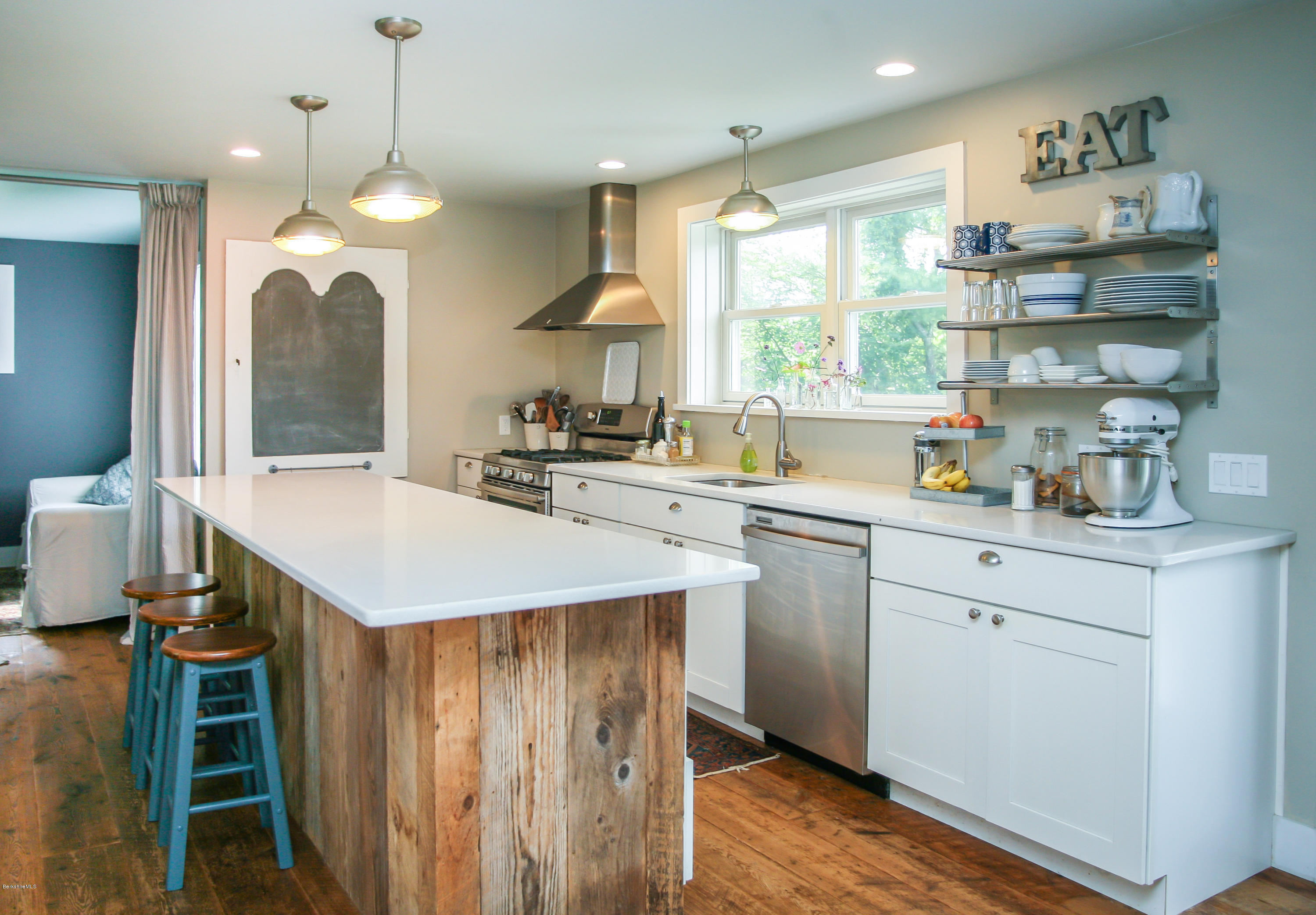 394 Main Road Monterey, MA 01245 - Photo 17 of 33 a kitchen with a table chairs sink and cabinets