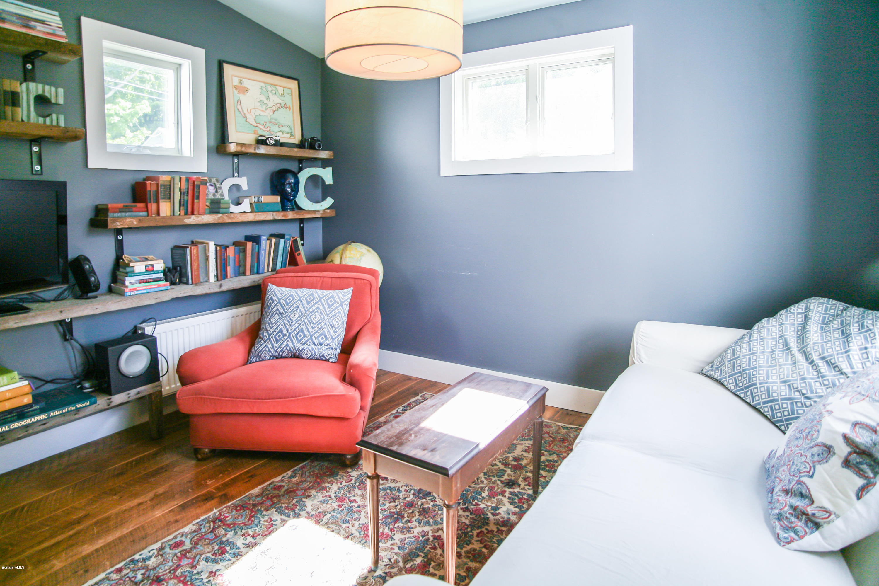 394 Main Road Monterey, MA 01245 - Photo 20 of 33 a bedroom with furniture and a book shelf