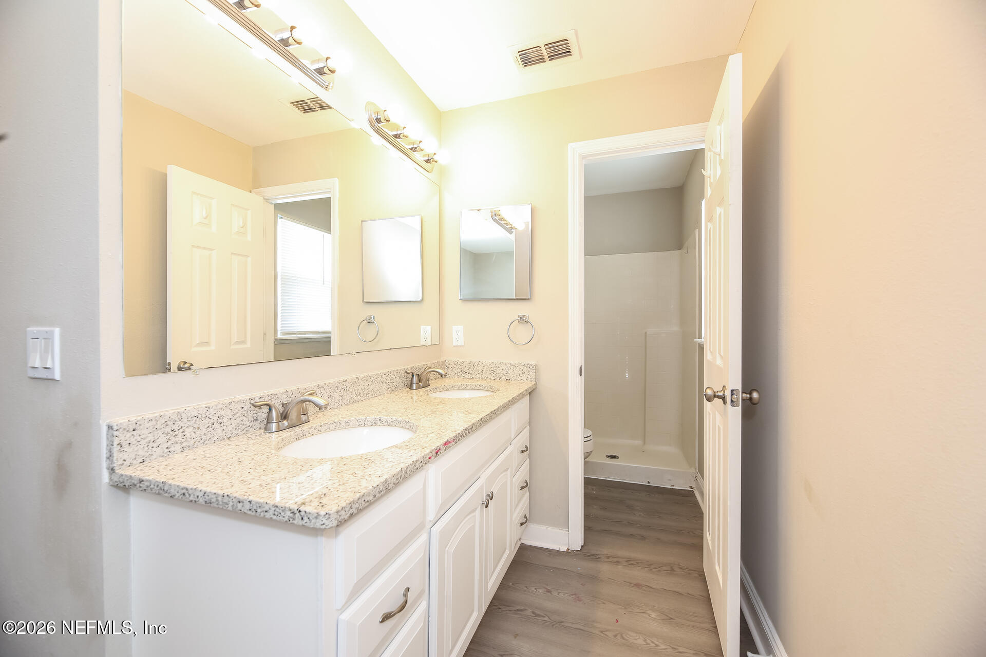 2652 Sunrise Ridge Lane Jacksonville, FL 32277 - Photo 12 of 22 a bathroom with a granite countertop sink and a mirror