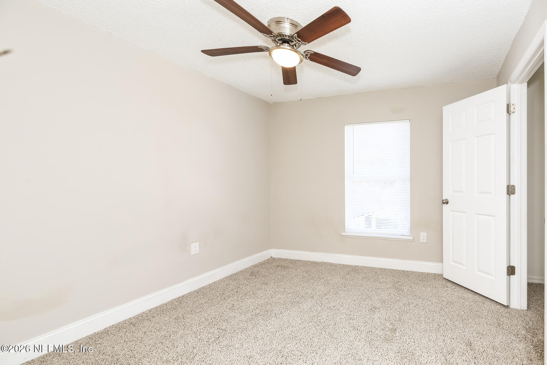 2652 Sunrise Ridge Lane Jacksonville, FL 32277 - Photo 17 of 22 an empty room with a window and a fan