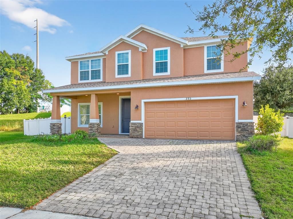 280 Wallrock Drive Ocoee, FL 34761 - Photo 2 of 88 a front view of a house with a yard and garage