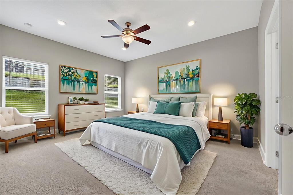 280 Wallrock Drive Ocoee, FL 34761 - Photo 27 of 88 a spacious bedroom with a bed a couch and a potted plant