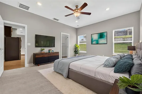 a view of an empty room with a ceiling fan