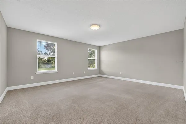 a bedroom with a large bed and a flat screen tv