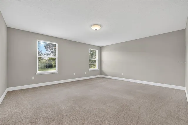 a bedroom with a large bed and a flat screen tv