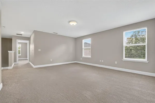 a view of an empty room with a ceiling fan