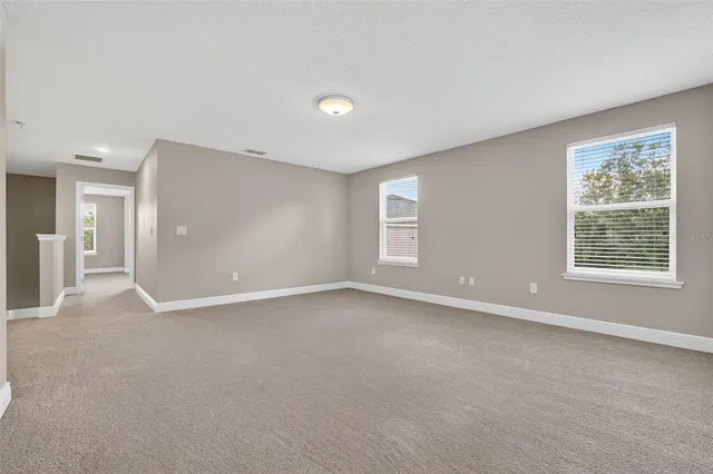a view of an empty room with a ceiling fan