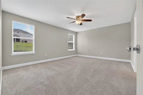 an aerial view of a house with a garden and lake view
