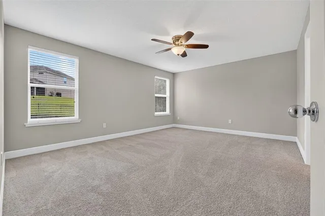 an aerial view of a house with a garden and lake view