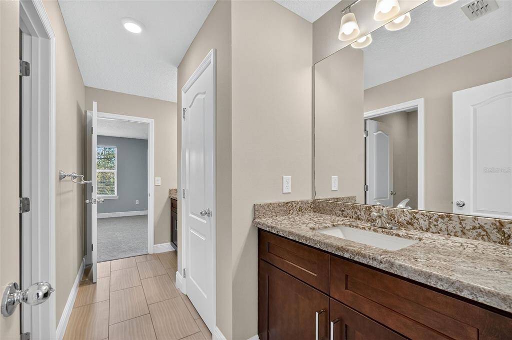 280 Wallrock Drive Ocoee, FL 34761 - Photo 48 of 88 a bathroom with a granite countertop sink and a mirror