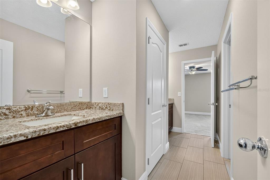280 Wallrock Drive Ocoee, FL 34761 - Photo 49 of 88 a bathroom with a granite countertop sink and a mirror