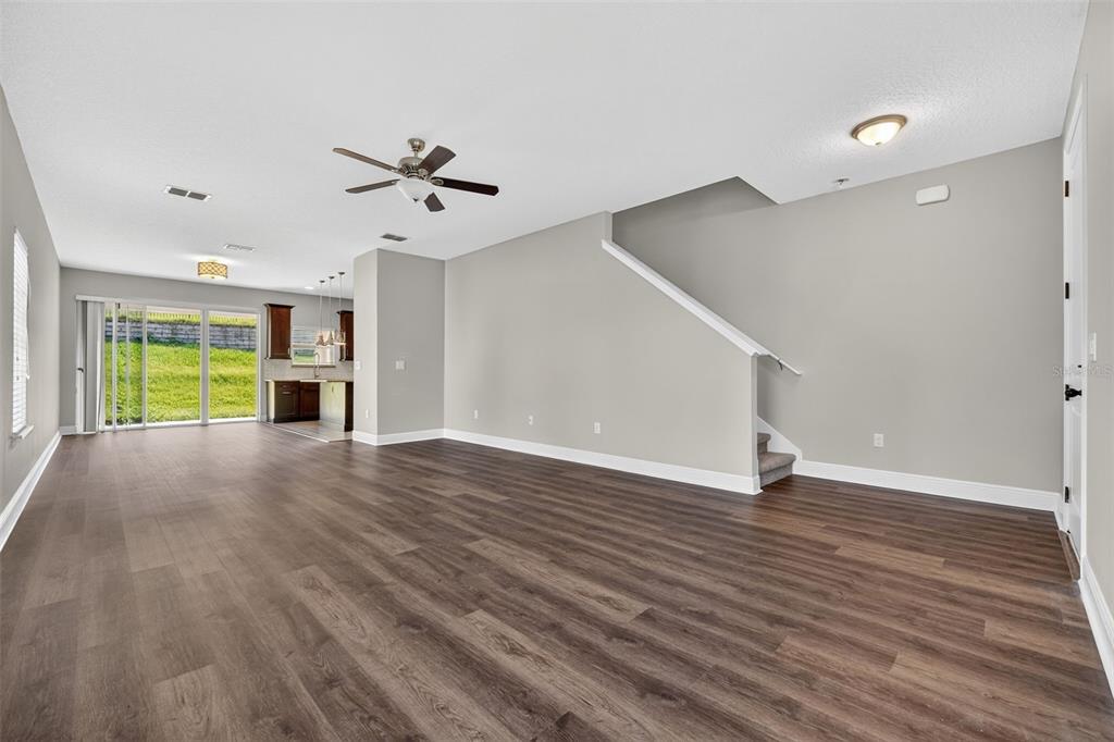 280 Wallrock Drive Ocoee, FL 34761 - Photo 10 of 88 a view of an empty room with window and wooden floor