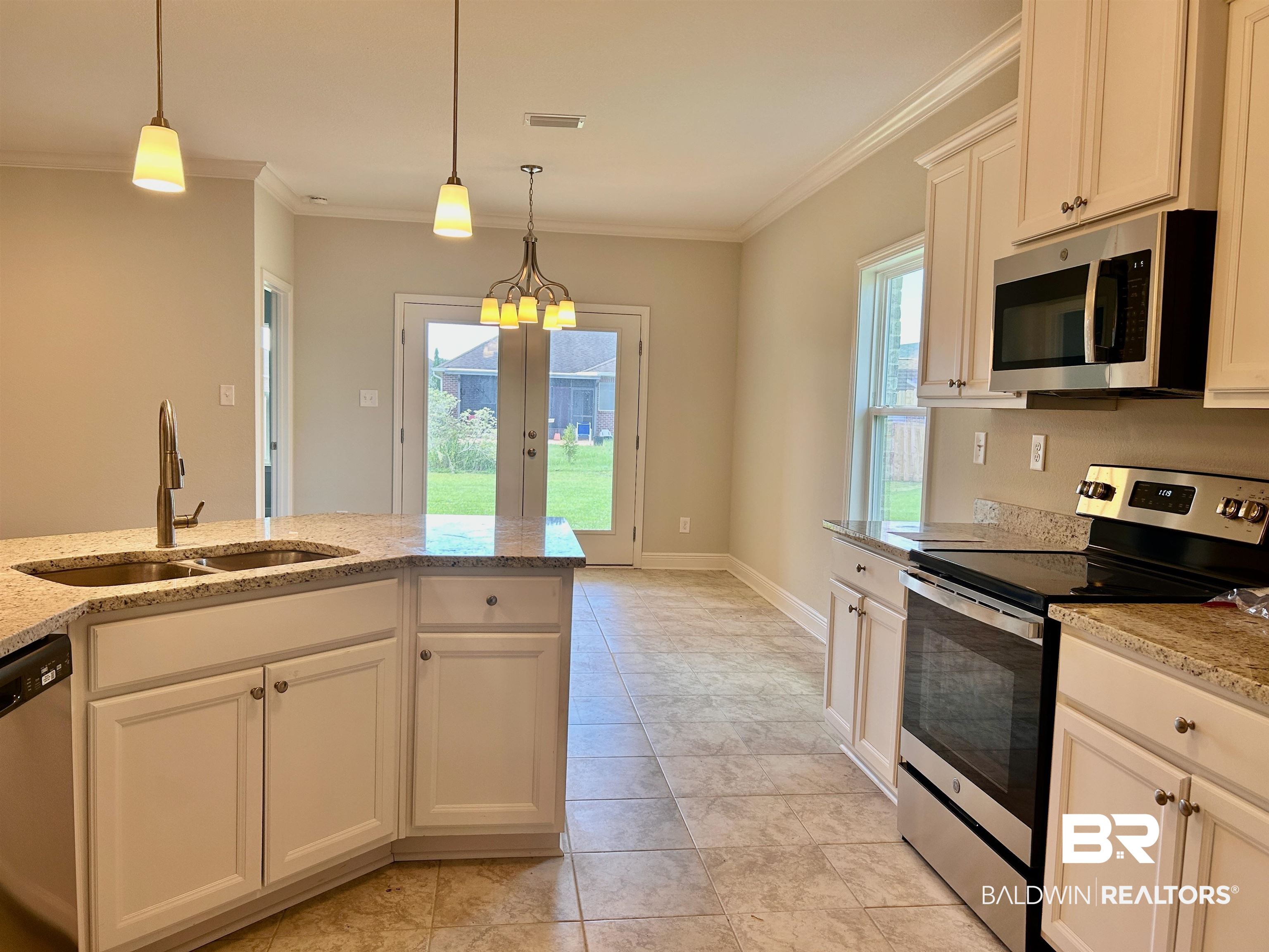 1267 Pembroke Way Foley, AL 36535 - Photo 10 of 17 Kitchen featuring appliances with stainless steel finishes, white cabinetry, light stone counters, and sink