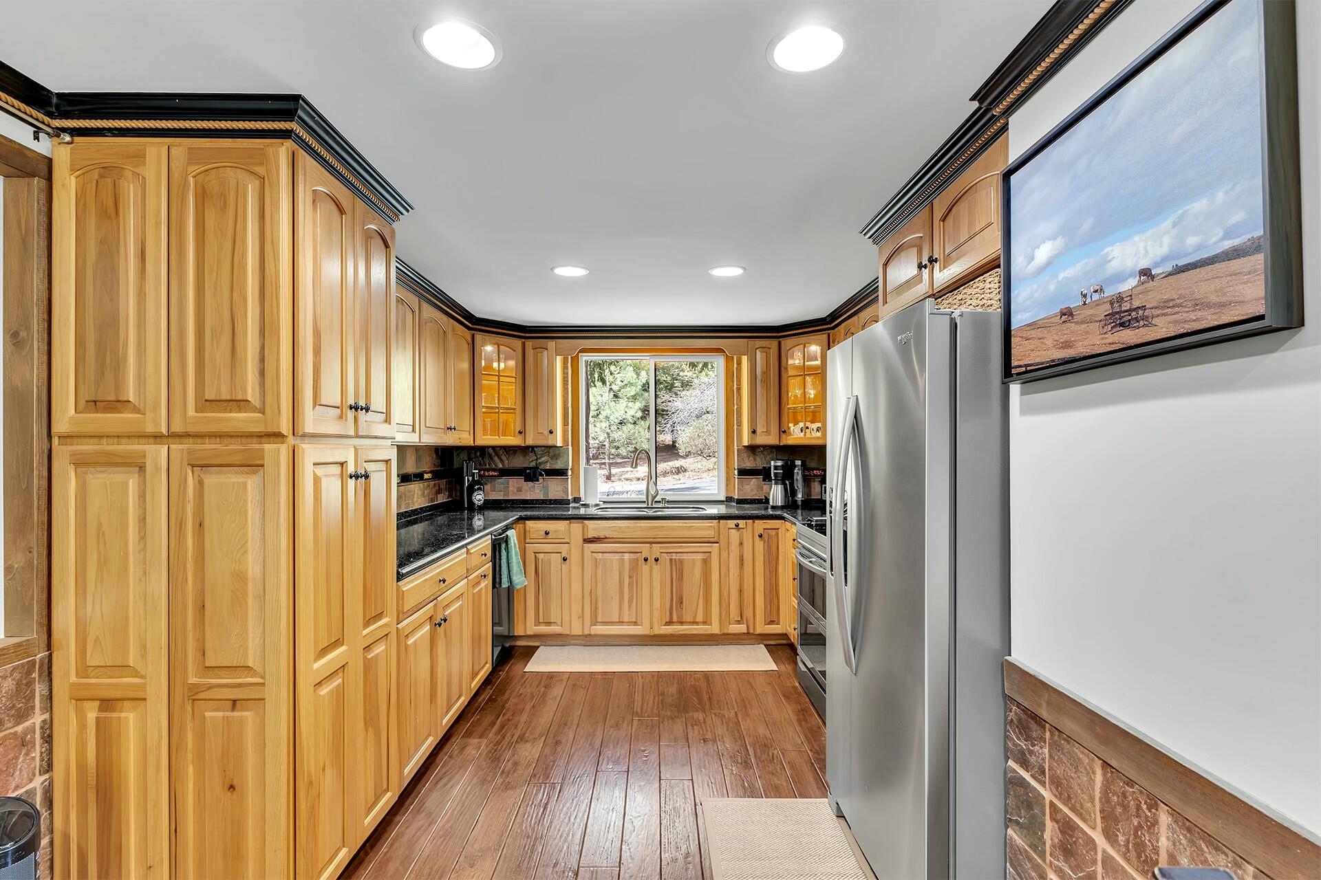 25622 Double Tree Drive Idyllwild, CA 92549 - Photo 21 of 65 a kitchen with stainless steel appliances granite countertop a refrigerator and a stove top oven
