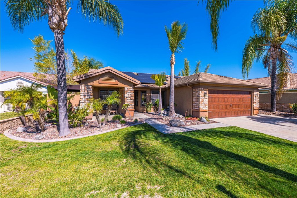 a view of a house with a yard patio and fire pit