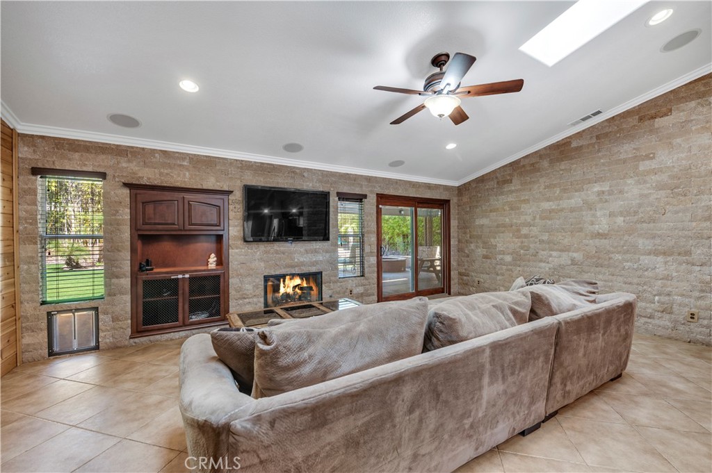 31584 Adour Way Winchester, CA 92596 - Photo 14 of 51 a living room with furniture and a fireplace