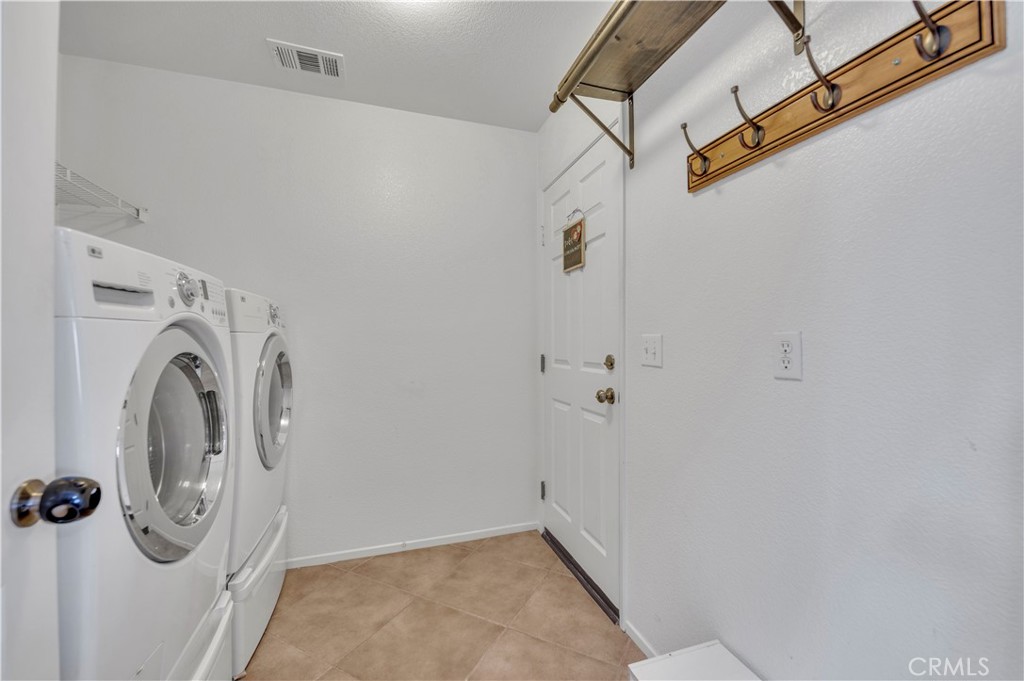 31584 Adour Way Winchester, CA 92596 - Photo 19 of 51 a view of a storage & utility room with a washer dryer