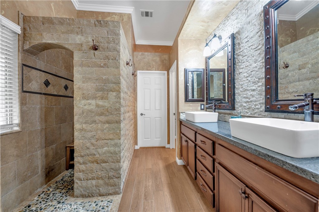 31584 Adour Way Winchester, CA 92596 - Photo 23 of 51 a spacious bathroom with a double vanity sink a mirror and shower