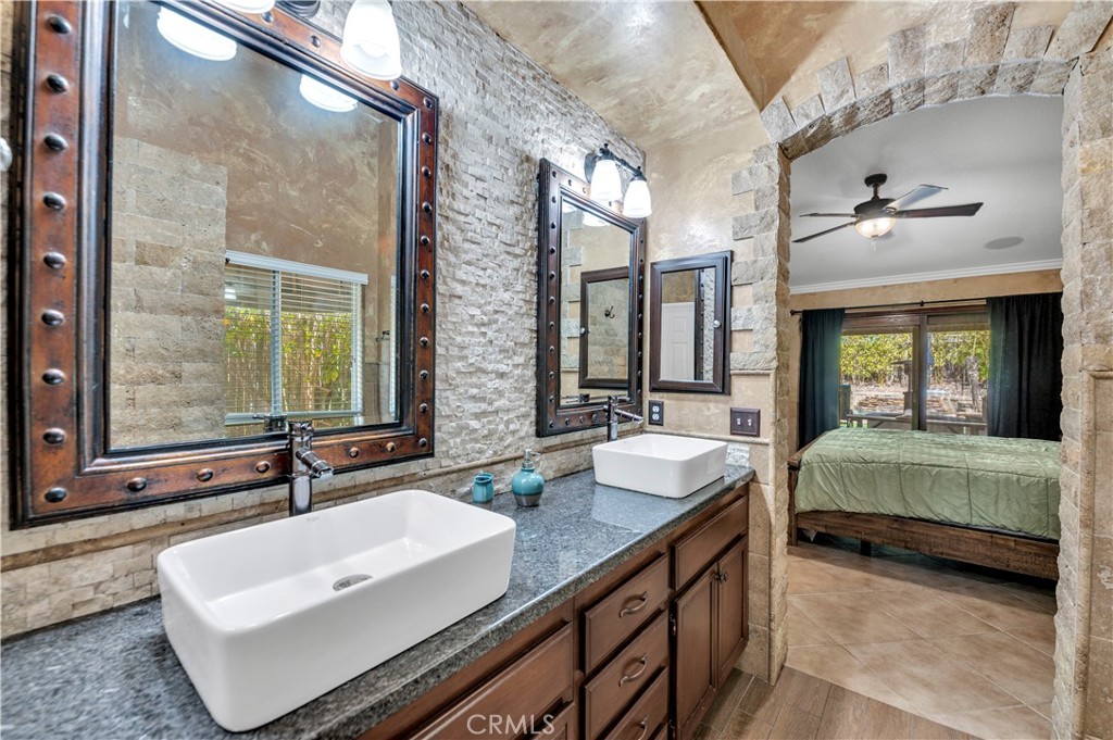 31584 Adour Way Winchester, CA 92596 - Photo 24 of 51 a bathroom with double vanity sinks and a mirror