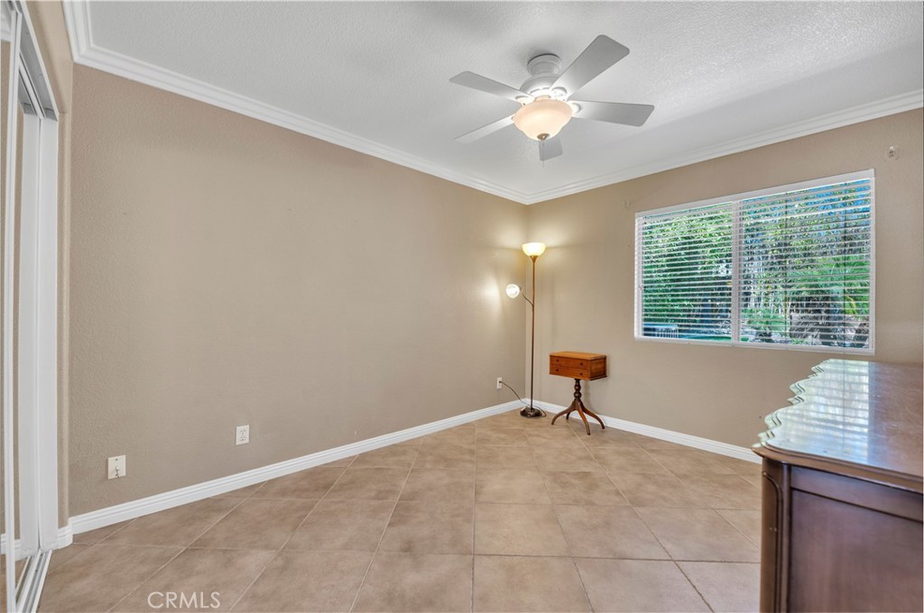 31584 Adour Way Winchester, CA 92596 - Photo 29 of 51 an empty room with windows and ceiling fan