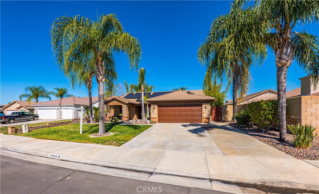 31584 Adour Way Winchester, CA 92596 - Photo 3 of 51 a view of a house with a yard and palm trees