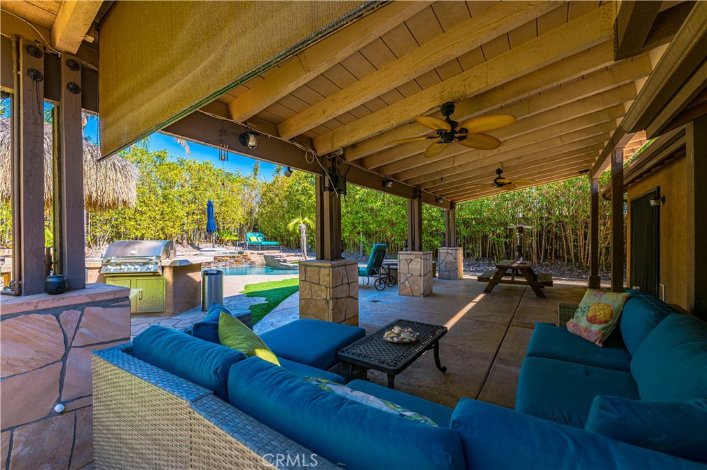 31584 Adour Way Winchester, CA 92596 - Photo 33 of 51 a outdoor space with patio the couches and pool table and chairs under an umbrella with a patio