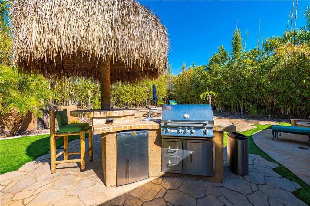 31584 Adour Way Winchester, CA 92596 - Photo 37 of 51 a view of a patio with table and chairs with wooden fence