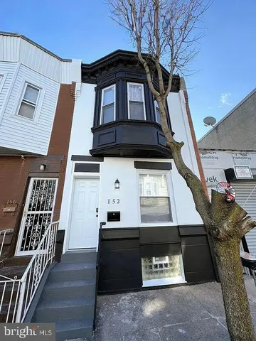 a front view of a house with stairs