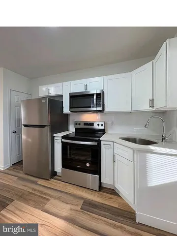 a kitchen with a refrigerator stove and microwave