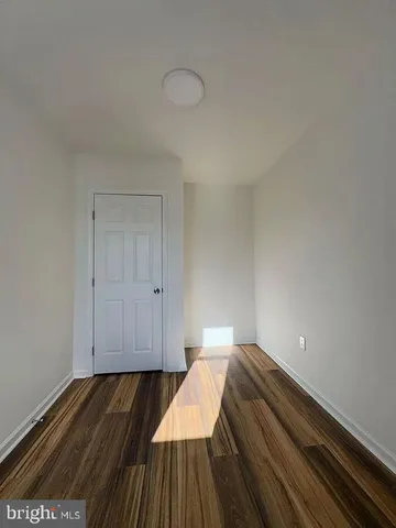 a view of a room with wooden floor and staircase
