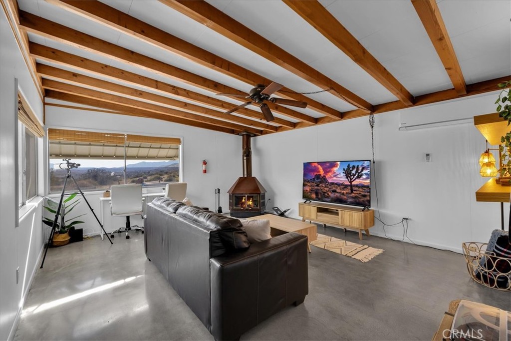 8500 South Samel Road Morongo Valley, CA 92256 - Photo 18 of 75 a living room with furniture and a flat screen tv