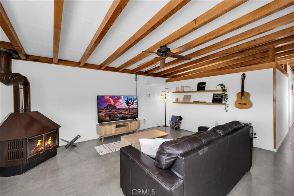 8500 South Samel Road Morongo Valley, CA 92256 - Photo 23 of 75 a living room with furniture and a flat screen tv